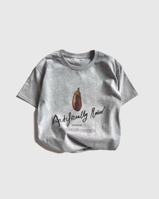 Unisex grey 'Artificially Raised' t-shirt by 10:AM Factory, featuring a bold big eggplant graphic print and 10:AM logo, crafted from high-quality, soft cotton for a clean, modern look.