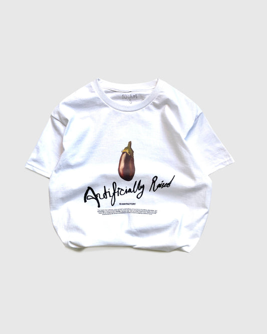 Unisex white 'Artificially Raised' t-shirt by 10:AM Factory, featuring a bold big eggplant graphic print and 10:AM logo, crafted from high-quality, soft cotton for a clean, modern look.