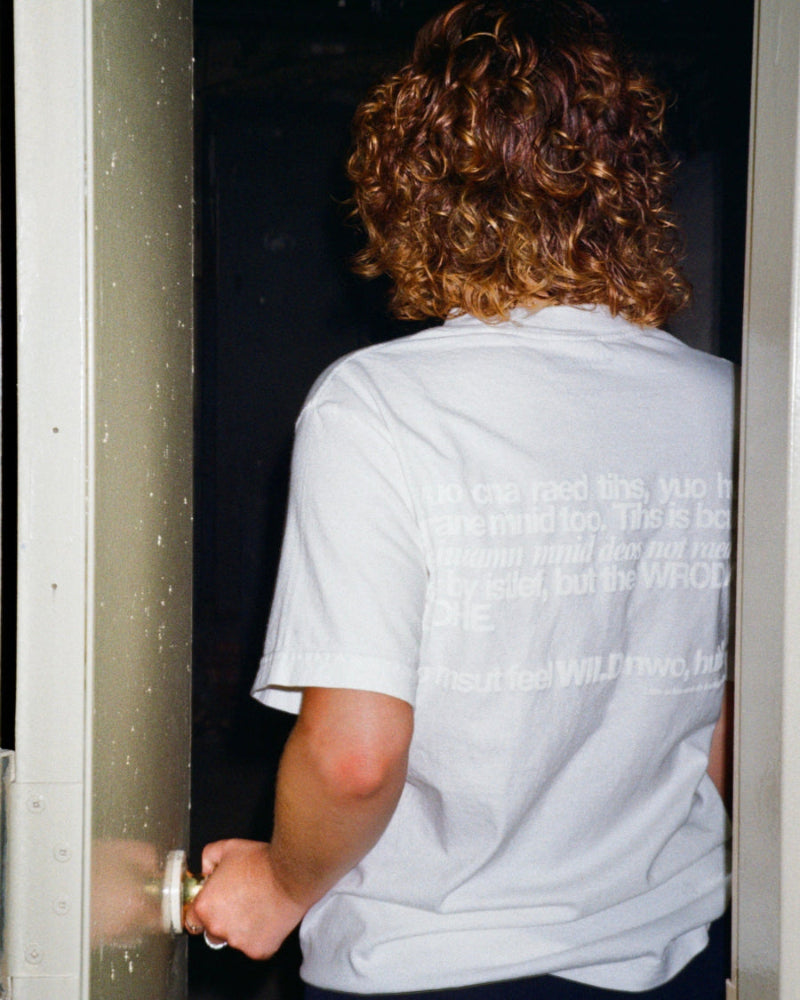 Unisex white 'Strange Mind' heavyweight t-shirt by 10:AM Factory, featuring a subtle white puff graphic print, crafted from high-quality, pigment-dyed cotton for a minimalist and timeless look.