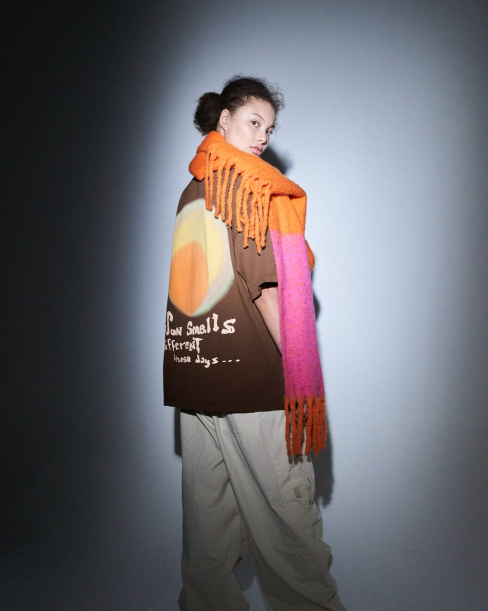 Unisex brown oversized t-shirt by 10:AM Factory, featuring the bold 'Sun Smells Different These Days' graphic print, crafted from high-quality, soft cotton for a relaxed, modern fit.