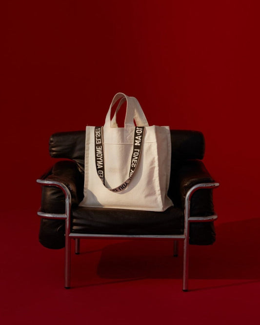 Unisex canvas tote bag by 10:AM Factory, featuring minimalist design and bold logo print, made from eco-friendly, sustainable materials.