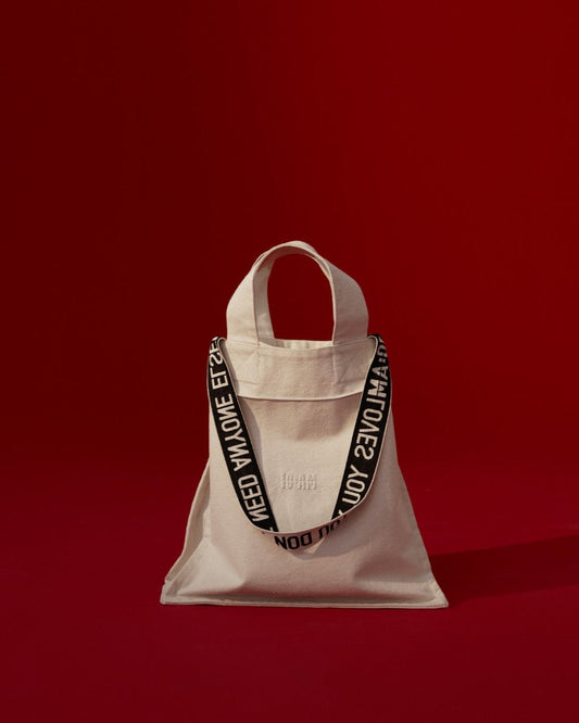 Unisex canvas tote bag by 10:AM Factory, featuring minimalist design and bold logo print, made from eco-friendly, sustainable materials.